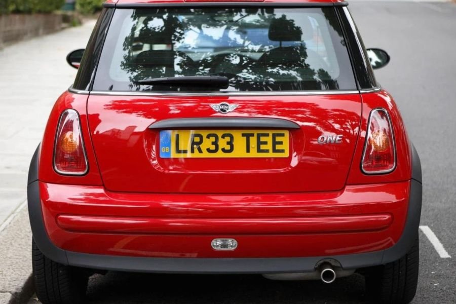 A red vehicle with car number plate